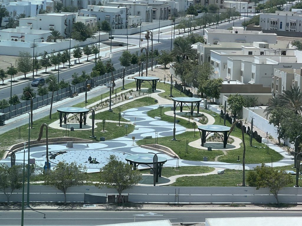 Aerial view of a finished park with circular shade gazebos